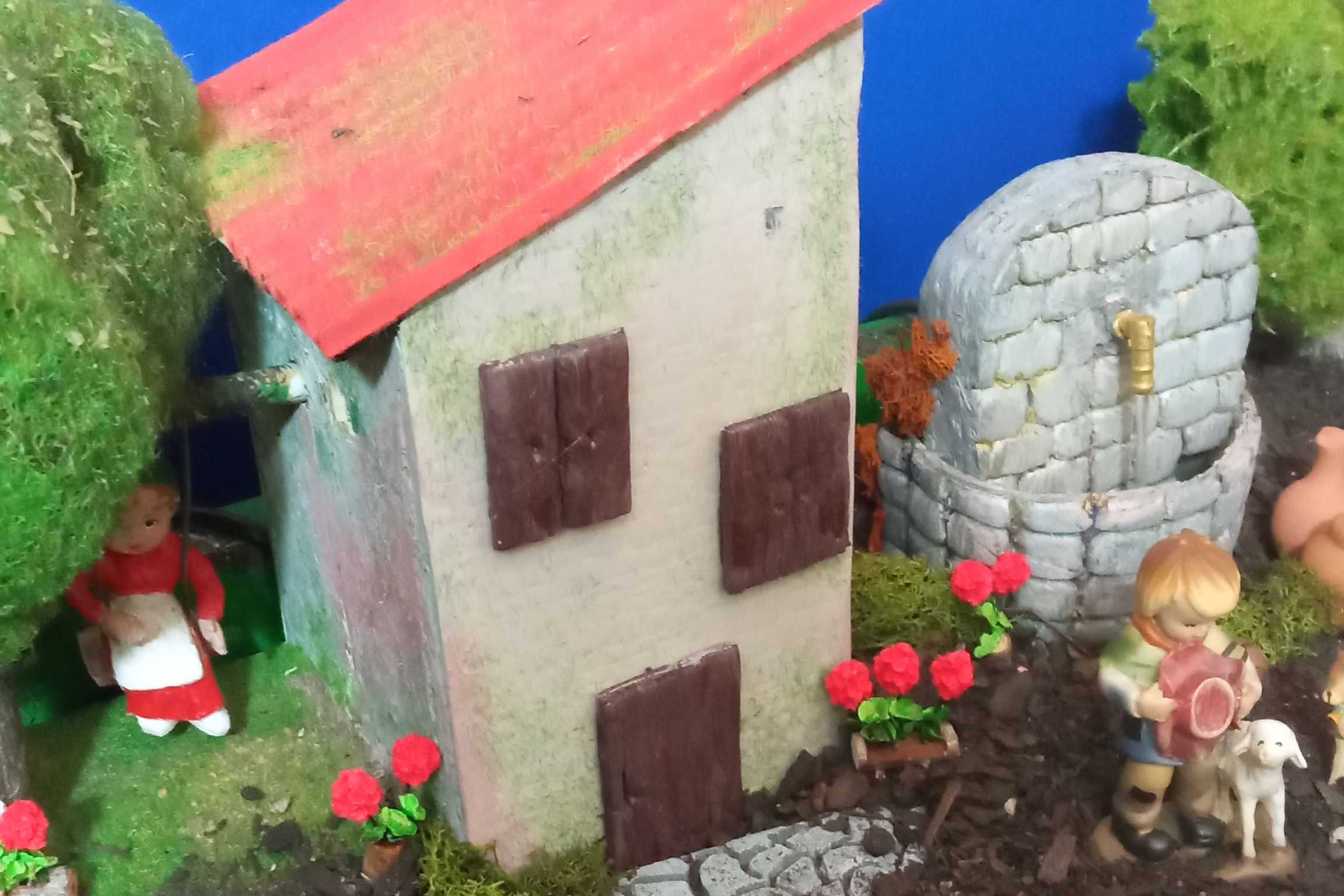 Escena exterior amb una casa al centre.